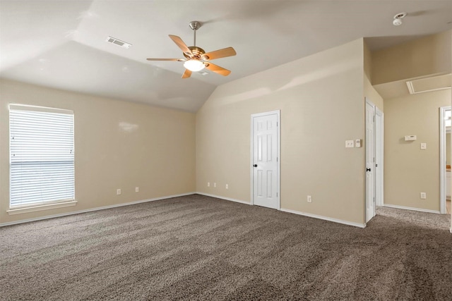 empty room featuring vaulted ceiling, carpet, and ceiling fan