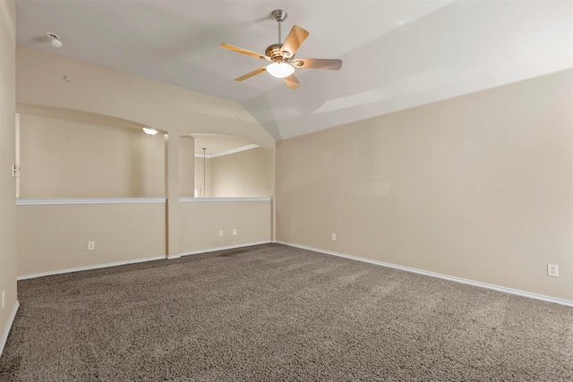 spare room featuring ceiling fan, carpet flooring, and vaulted ceiling