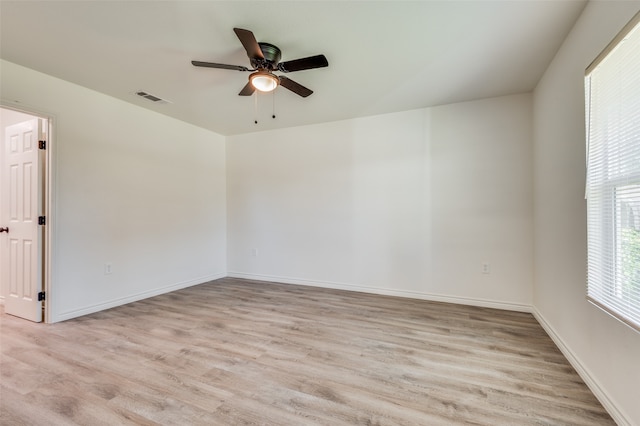 empty room featuring ceiling fan and light hardwood / wood-style flooring