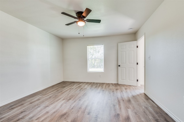 spare room with light hardwood / wood-style flooring and ceiling fan