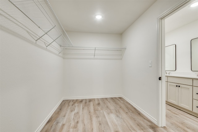 spacious closet featuring light wood-type flooring