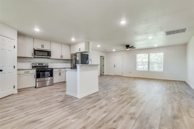 kitchen featuring white cabinetry, light wood-type flooring, stainless steel appliances, and ceiling fan