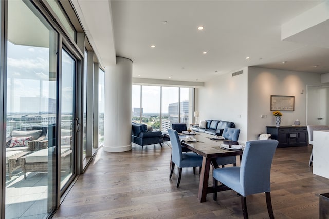 dining area with dark wood-type flooring and decorative columns