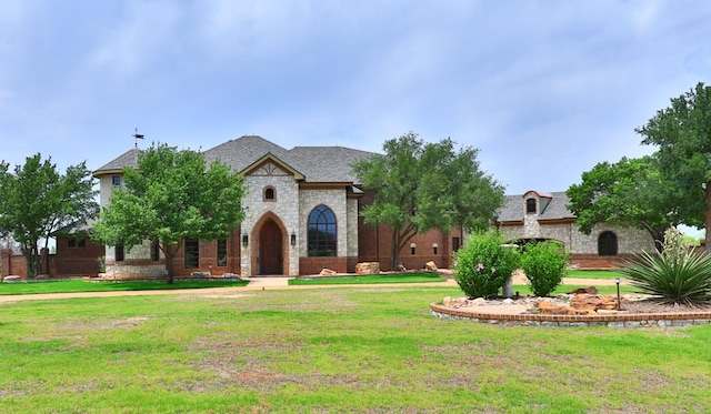 french country style house with a front yard