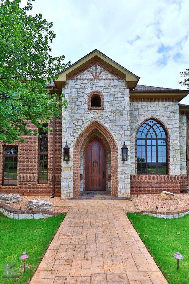 property entrance featuring a lawn