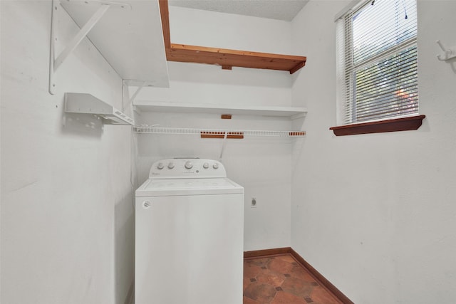 laundry room featuring washer / clothes dryer and a textured ceiling