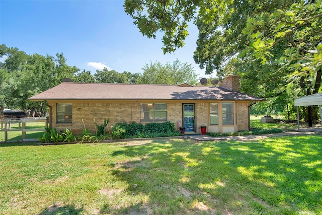 exterior space with a carport and a front lawn