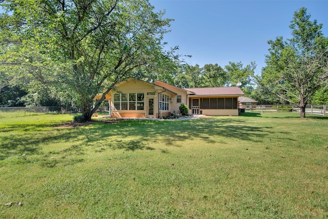 exterior space featuring a front yard and a sunroom