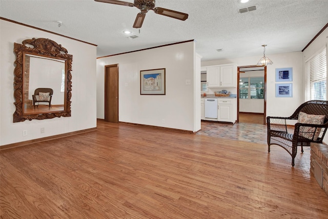 living room with ceiling fan, crown molding, light hardwood / wood-style floors, and a textured ceiling