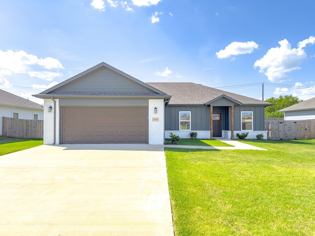 ranch-style home featuring a front lawn and a garage