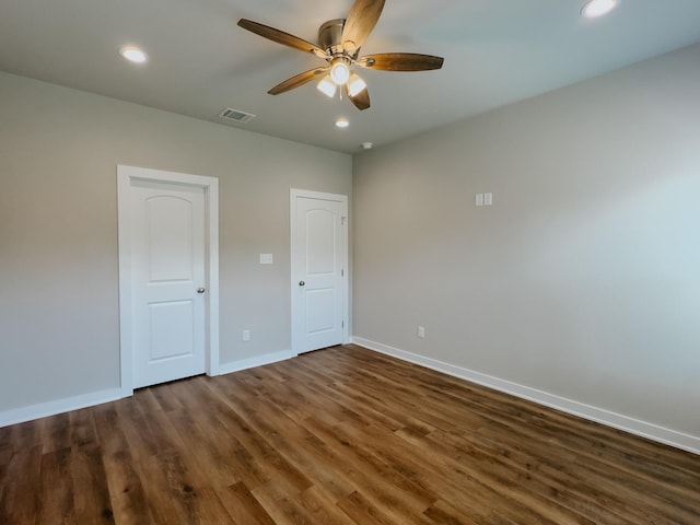 unfurnished bedroom with dark hardwood / wood-style flooring and ceiling fan