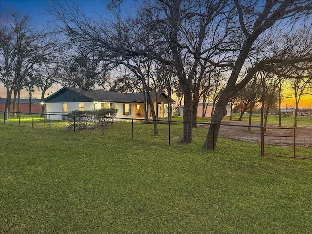 view of yard at dusk