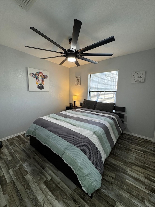 bedroom featuring ceiling fan and dark wood-type flooring