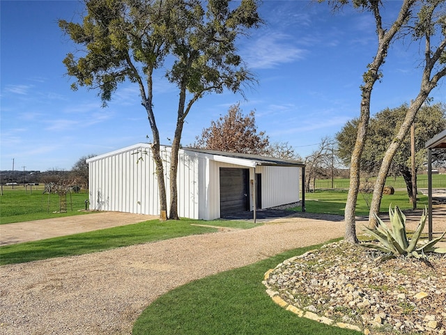 view of outbuilding featuring a lawn