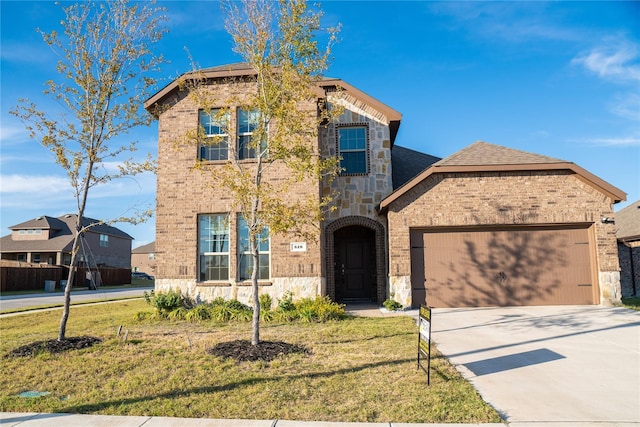 view of front of house with a front yard and a garage