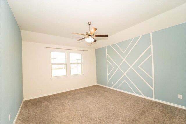 carpeted spare room featuring ceiling fan