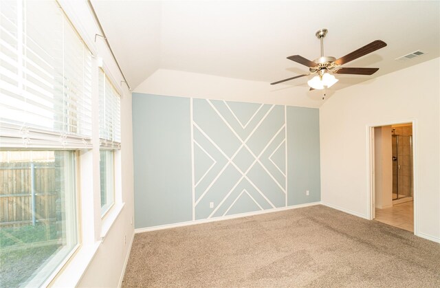 carpeted spare room with lofted ceiling and ceiling fan