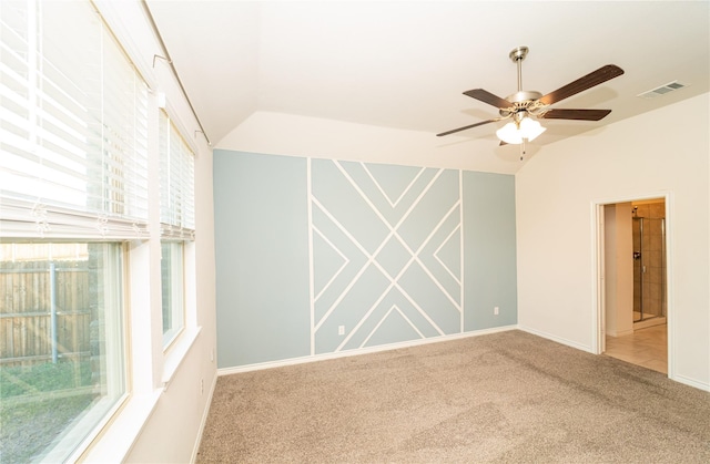 empty room featuring carpet flooring, ceiling fan, and lofted ceiling