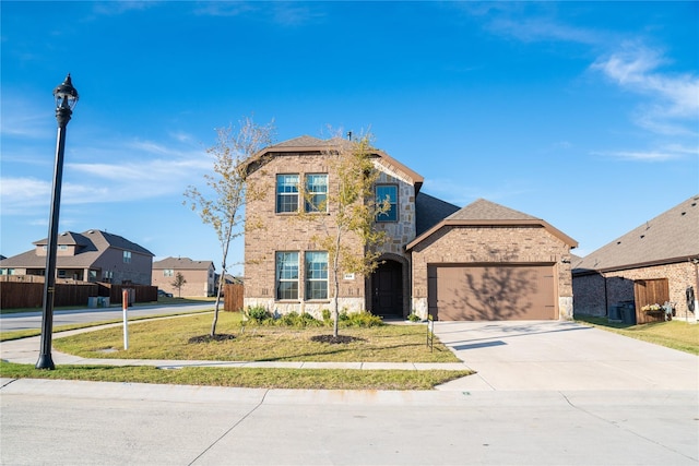 front facade featuring a front lawn and a garage