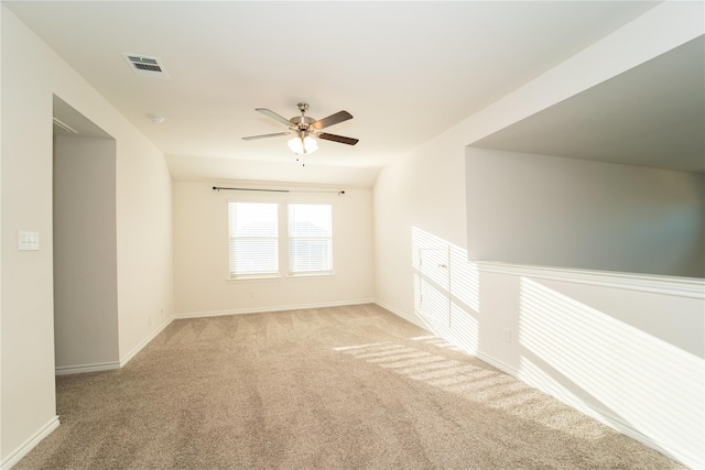 carpeted spare room with ceiling fan