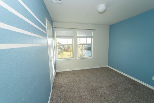 empty room featuring dark carpet