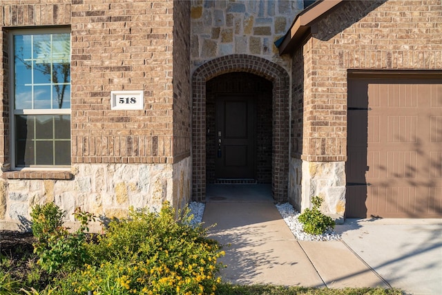 doorway to property with a garage