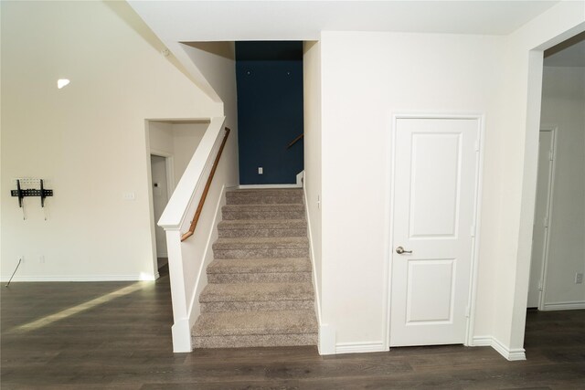 stairs featuring dark hardwood / wood-style flooring