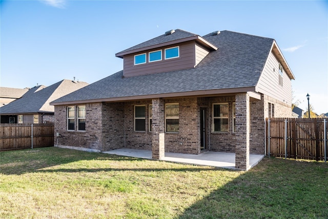 back of house featuring a lawn and a patio