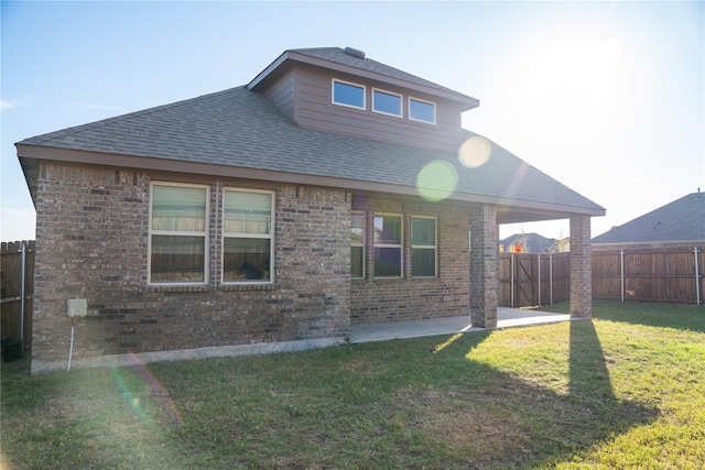 back of house featuring a patio and a lawn