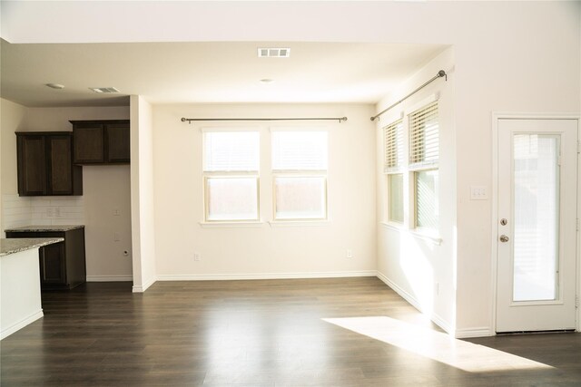 unfurnished living room featuring dark hardwood / wood-style flooring