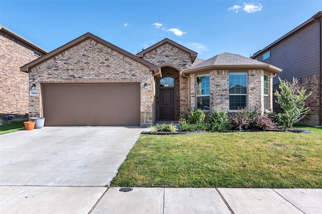 view of front of house with a garage, a front yard, brick siding, and driveway