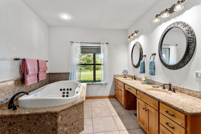 bathroom featuring tile patterned flooring, vanity, and tiled bath