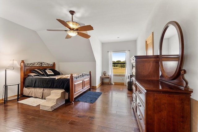 bedroom with ceiling fan, dark hardwood / wood-style flooring, and lofted ceiling