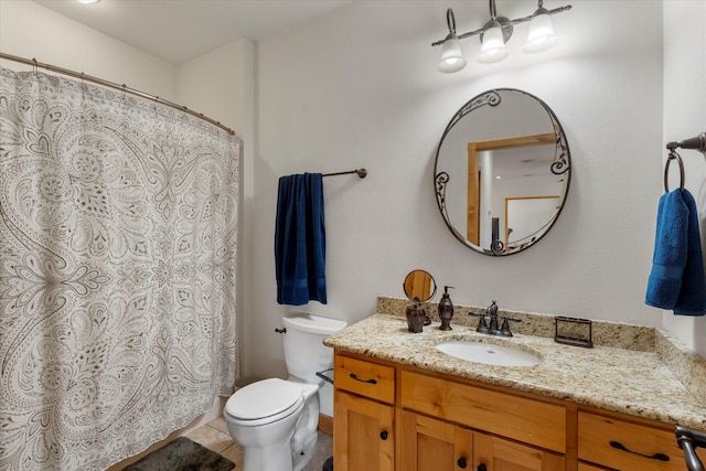 bathroom with tile patterned flooring, vanity, and toilet