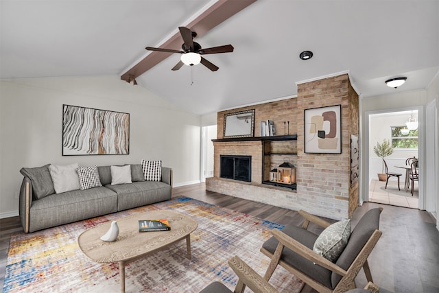 living room featuring a fireplace, vaulted ceiling with beams, dark hardwood / wood-style flooring, and ceiling fan