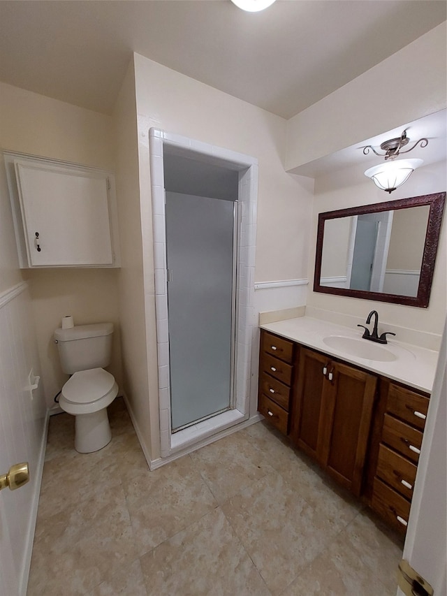 bathroom with vanity, toilet, and an enclosed shower