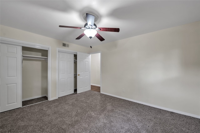 unfurnished bedroom featuring dark carpet and ceiling fan