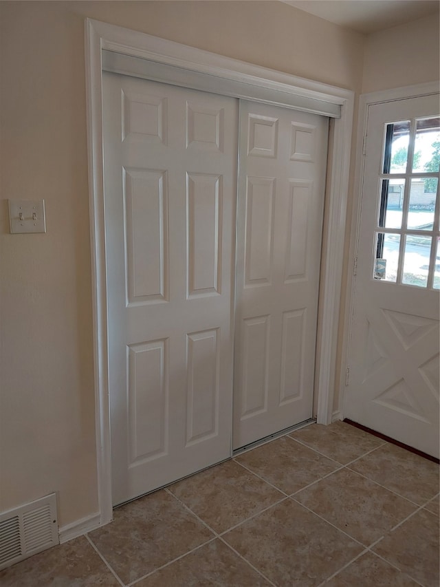 doorway featuring light tile patterned flooring