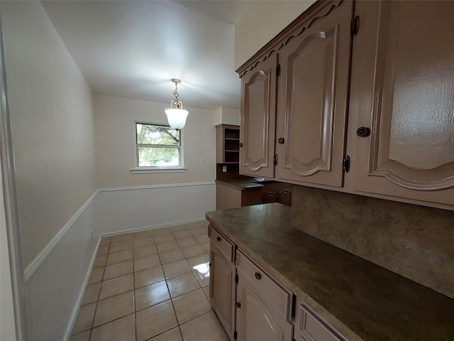 kitchen with decorative light fixtures and light tile patterned floors