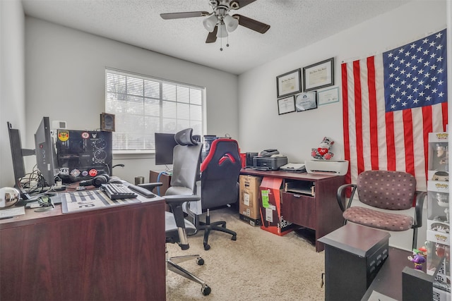 carpeted home office with ceiling fan and a textured ceiling