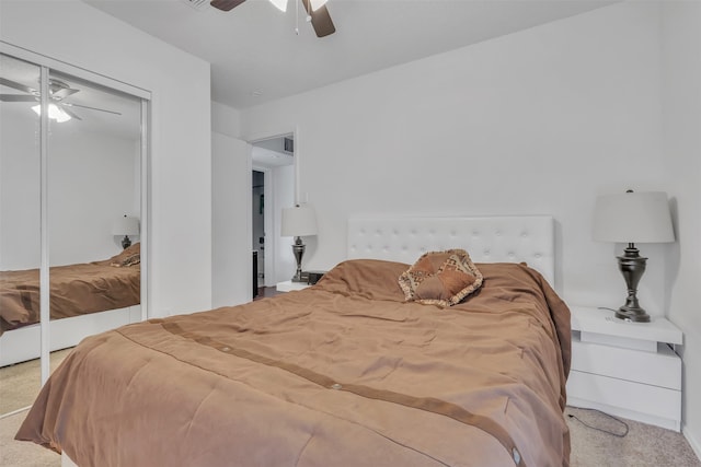 carpeted bedroom featuring a closet and ceiling fan