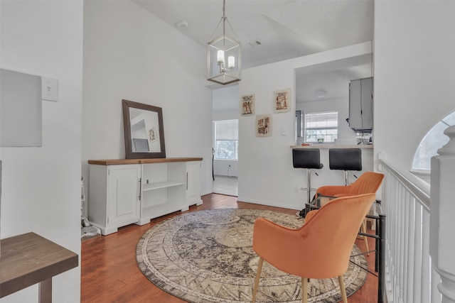 interior space with a towering ceiling and hardwood / wood-style floors