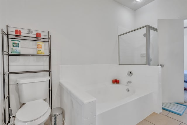 bathroom with separate shower and tub, toilet, and tile patterned floors