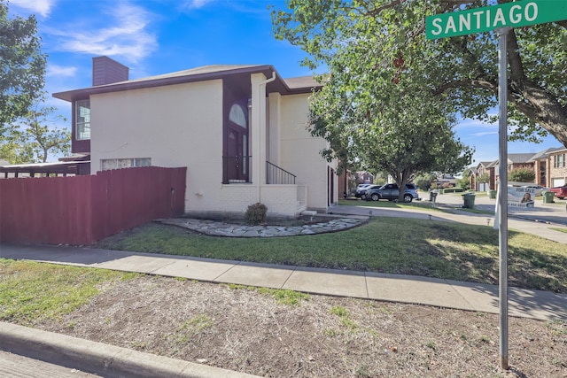 view of property exterior with a yard