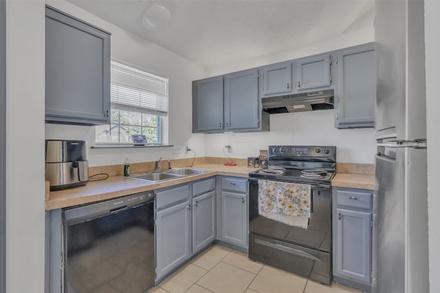 kitchen featuring gray cabinets, black appliances, light tile patterned flooring, and sink