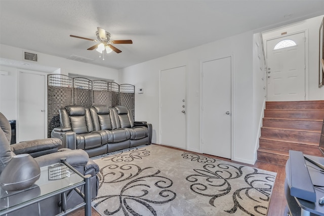 living room featuring wood-type flooring and ceiling fan