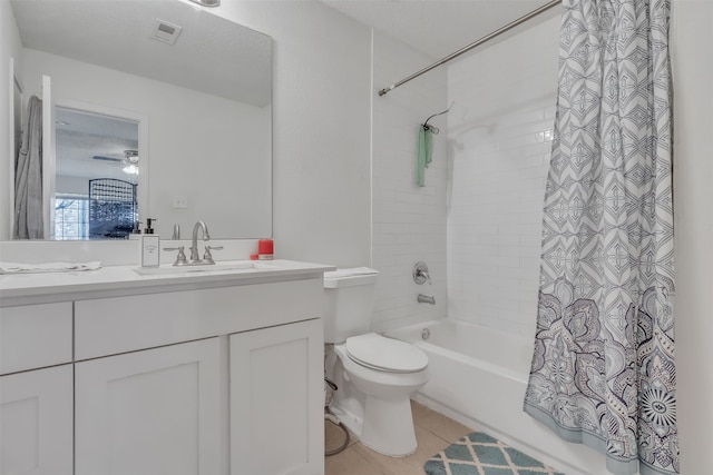 full bathroom featuring shower / bath combo, tile patterned floors, ceiling fan, vanity, and toilet