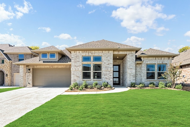 prairie-style house with a garage and a front yard