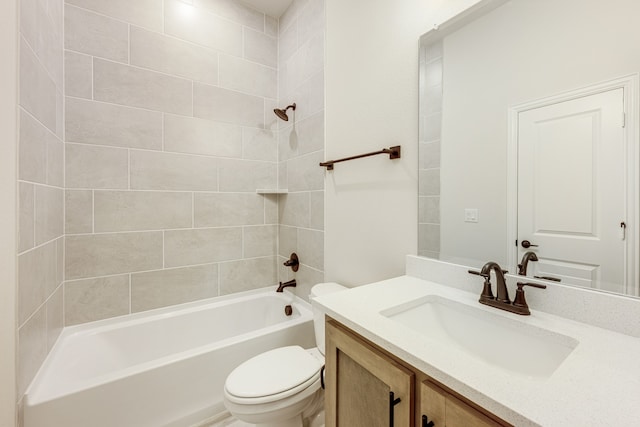 full bathroom featuring vanity, tiled shower / bath combo, and toilet