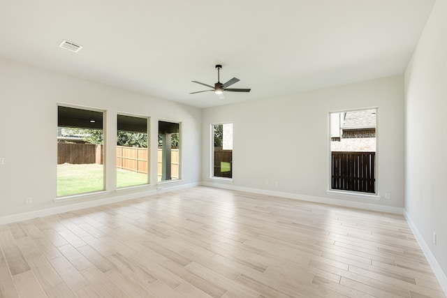 empty room featuring ceiling fan and light hardwood / wood-style floors